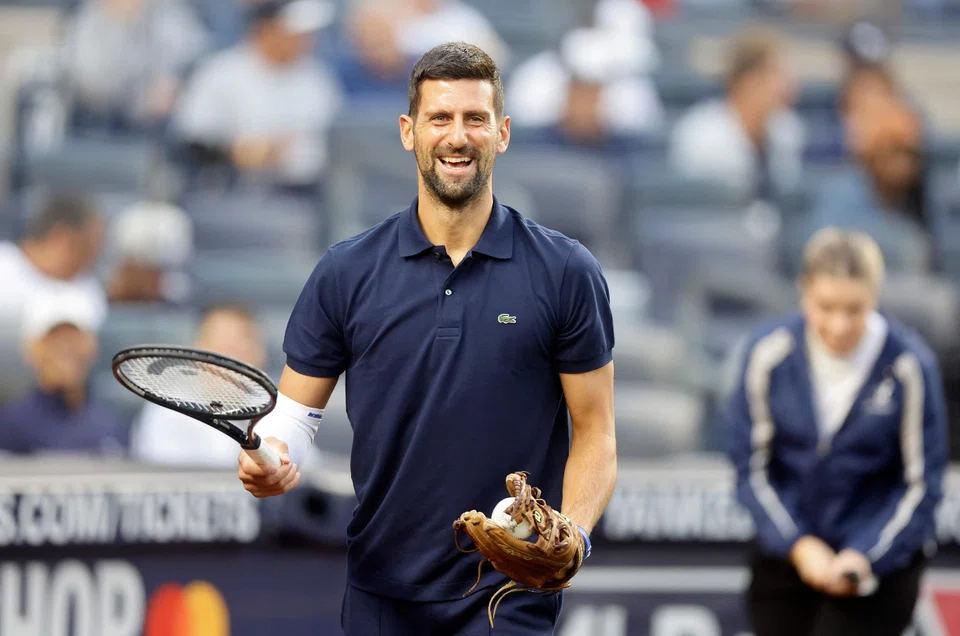 Novak Djokovic preparing to throw the ceremonial first pitch prior to a baseball game in New York on Aug 21. The 38-year-old is chasing his 25th Grand Slam title at the US Open.