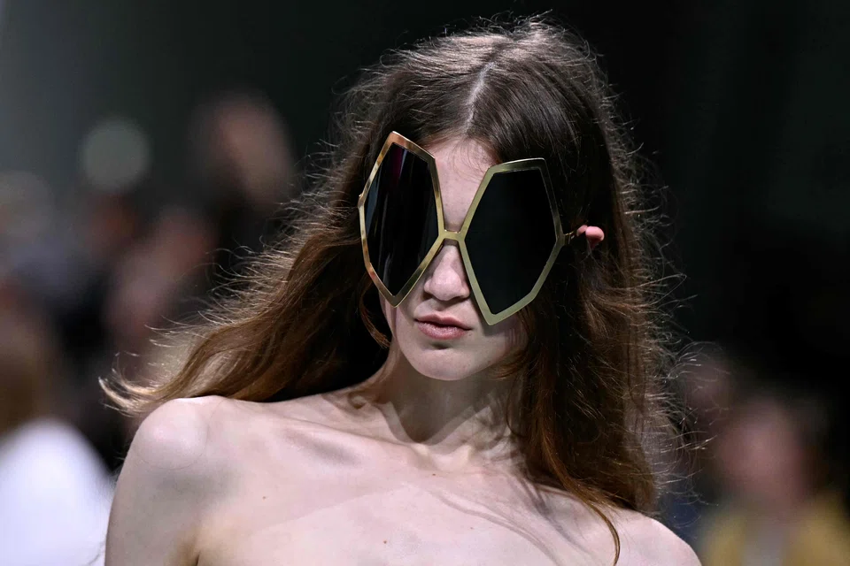 Accessories included huge sunglasses (top) and topless goggle-like bucket hats that covered faces.