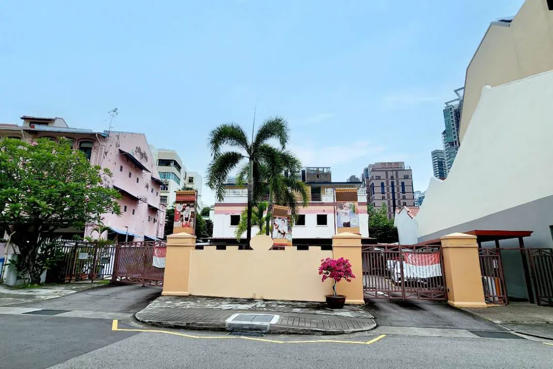 The site is currently occupied by a pair of three-storey semi-detached houses and a childcare centre.