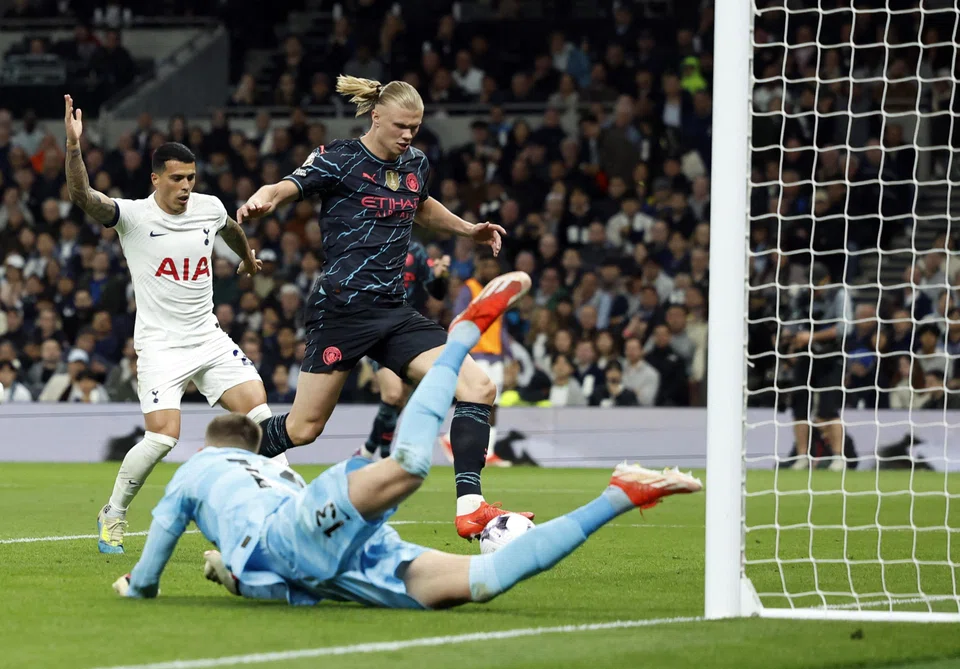 Manchester City's Erling Haaland scores their first goal past Tottenham Hotspur's Guglielmo Vicario at the Tottenham Hotspur Stadium, London, Britain, May 14, 2024