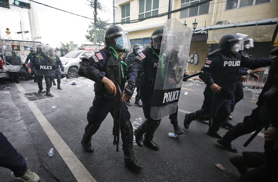 Thai riot police officers move to disperse anti-government protester during a protest against the Apec Summit in Bangkok on Nov 18, 2022. Anti-government protesters held a demonstration calling for the resignation of Thai Prime Minister Prayut Chan-o-cha.