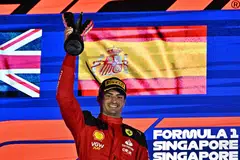 Ferrari's Spanish driver Carlos Sainz Jr celebrating on the podium after winning the Singapore Formula One Grand Prix.