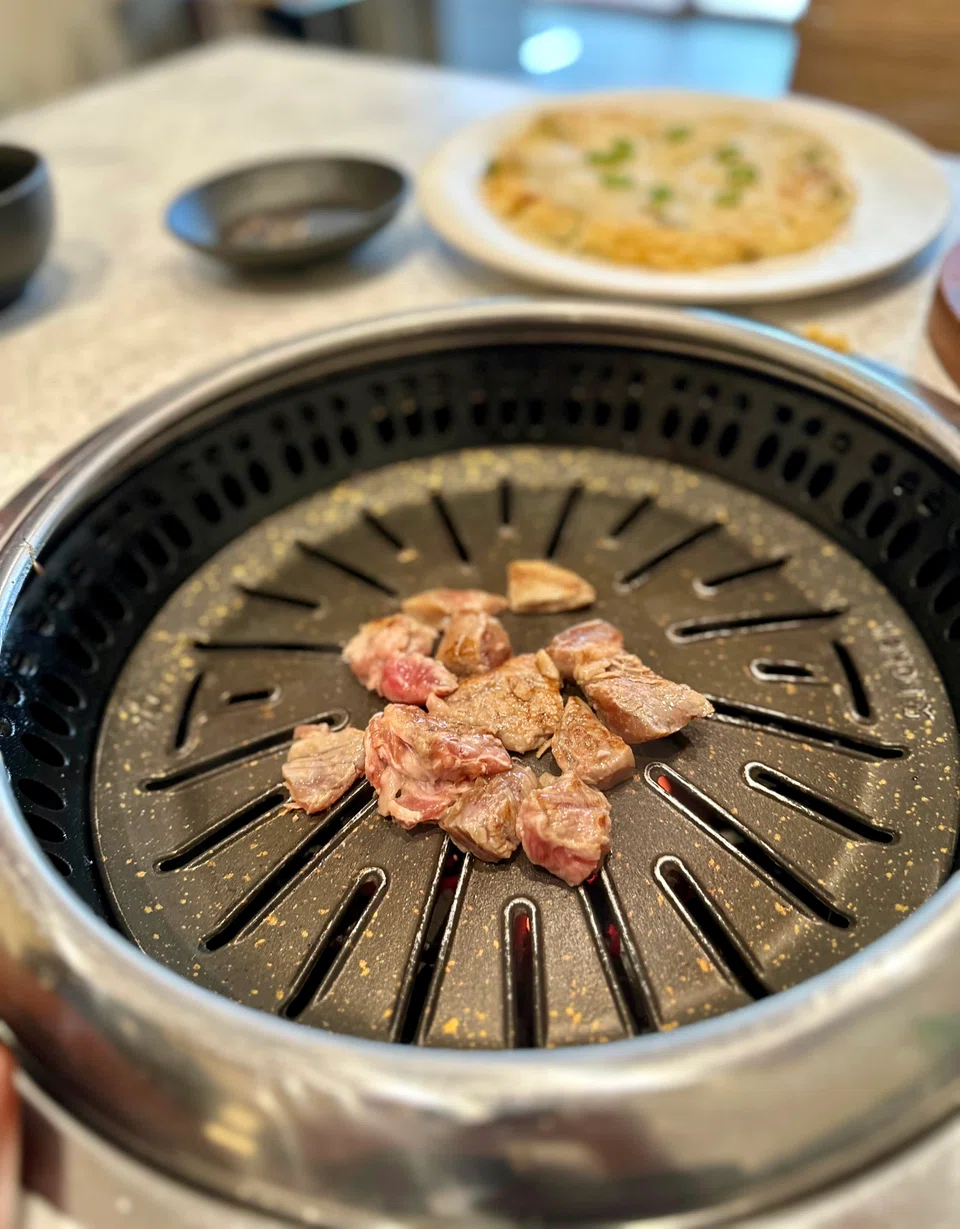 The meat is cooked for you over a smokeless grill.