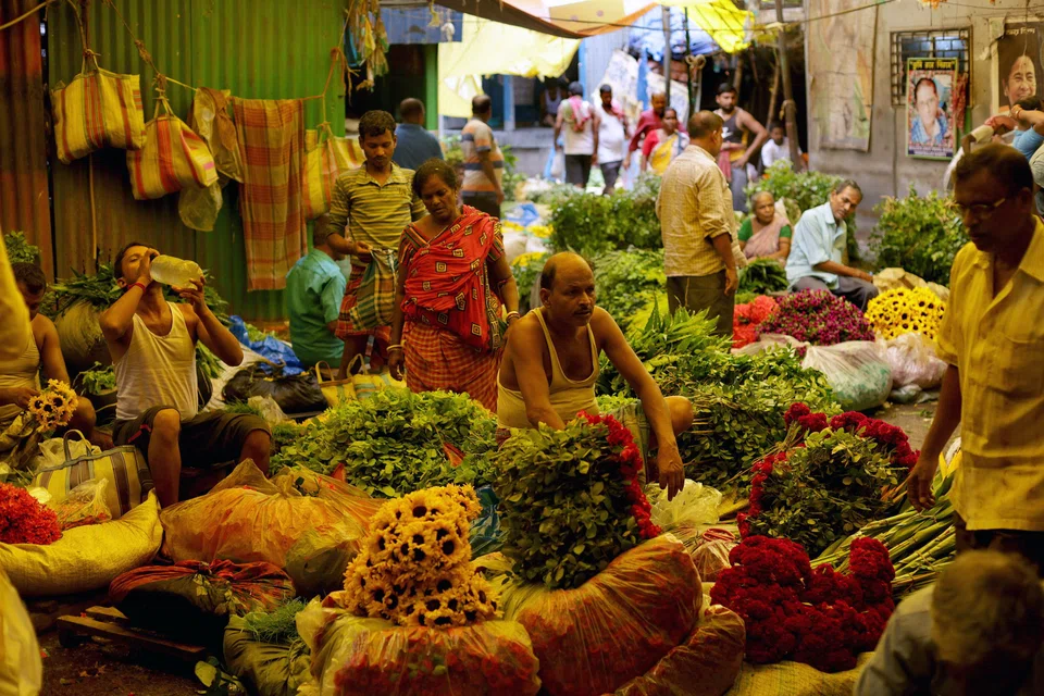 Indian flower vendors at the Mallick Ghat flower market, in Kolkata, India, July 23, 2024. 