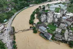 A damaged bridge and submerged buildings at a flood-affected village in Kaili, China, June 28, 2025. 