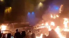 Protesters gather as vehicles burn, amid evolving anti-government unrest, in Teheran.