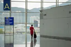 A flight attendant for Cathay Pacific Airways at Hong Kong International Airport. 