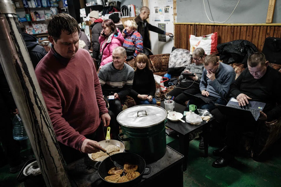A volunteer cooks for people at a humanitarian centre in Bakhmut, Ukraine. While oligarchic capitalism persists in the country, its civil society is pushing back.