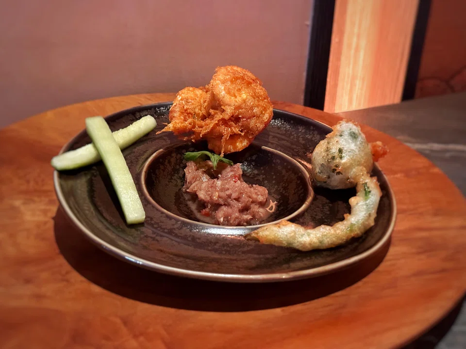 A funky, pungent shrimp paste relish outshines the tempura shrimp and broccolini.