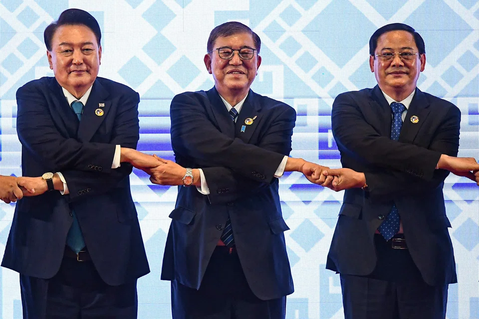 (From left) South Korean President Yoon Suk-yeol, Japanese Prime Minister Shigeru Ishiba and Lao Prime Minister Sonexay Siphandone link hands for the Asean handshake at the 27th Asean+3 Summit on Thursday (Oct 10).
