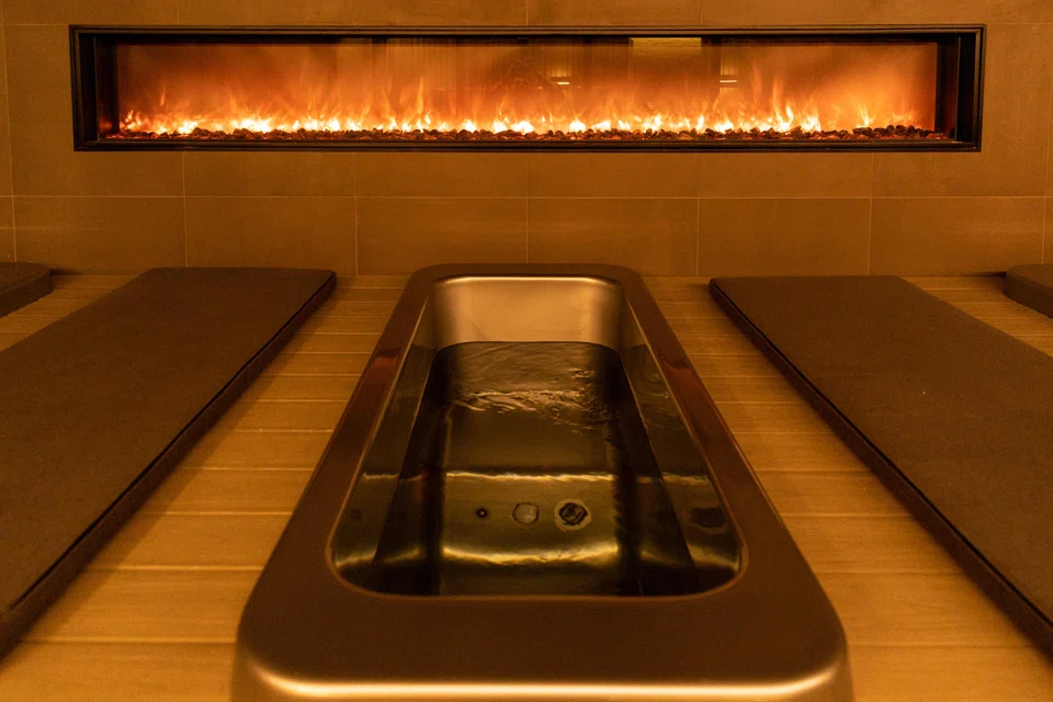 The Ice Bath Studio on the lower level of Remedy Place in Manhattan. Across the US, firms are entertaining clients with foot rubs and sound baths, while team brainstorming sessions are taking place in ice plunges and infrared saunas. Meetings with current or potential bosses are happening over IV infusions. 