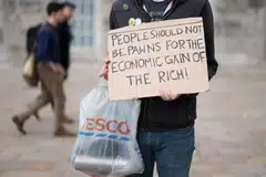 A protester at a demonstration against the Conservative Party's annual autumn conference organised by The People's Assembly campaign group in Birmingham, UK, on Sunday (Oct 2). At a time when the people are dealing with record inflation, the plan to scrap the cut in taxes for the country's highest earners has drawn a lot of unhappiness in and outside the Conservative party.  