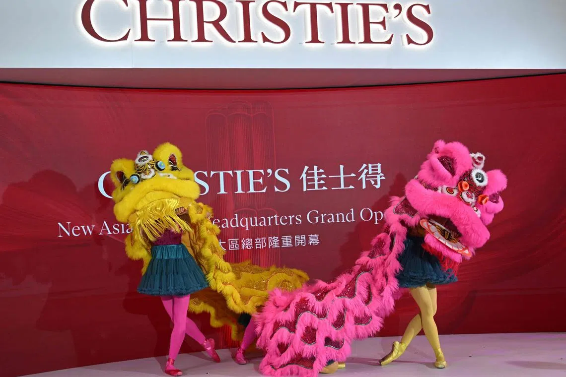Lion dancers perform in front of guests at the official unveiling of Christie’s new Asia Pacific headquarters at the Henderson Centre in Hong Kong.