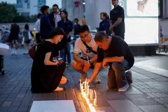 Candles being placed outside the luxury Siam Paragon shopping mall in Bangkok on Wednesday (Oct 4), where two people had been killed and five wounded in a shooting the previous day. 