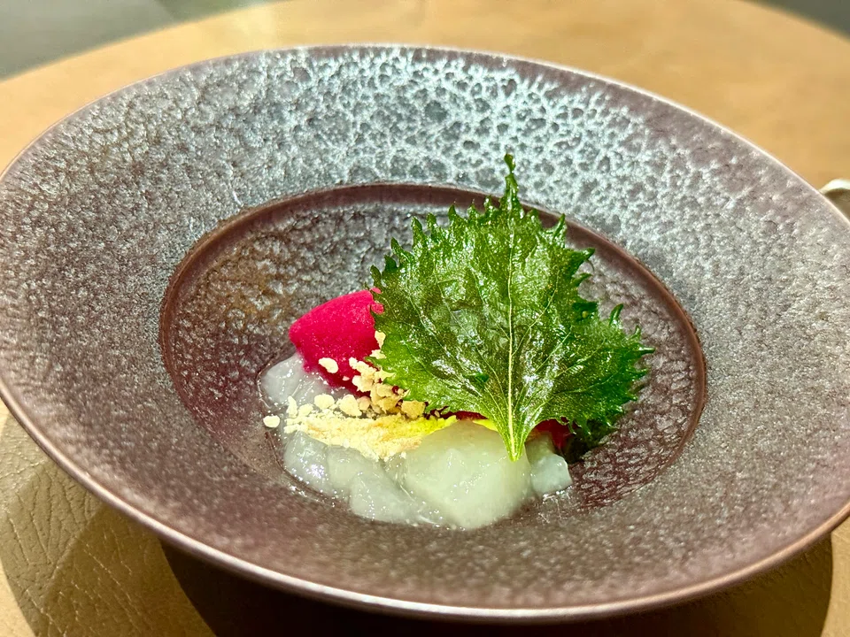 Red shiso sorbet and doburoku jelly are rounded off with shiso leaf and crushed meringue bits.