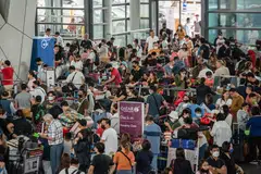 Several of the airport’s four terminals were crowded on Monday, with long queues of people trying to rebook flights while other weary passengers slept on chairs or on the floor.