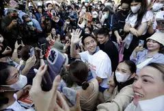 Pita Limjaroenrat (centre), the Move Forward Party's candidate for prime minister, greeting supporters during a campaign in Bangkok.