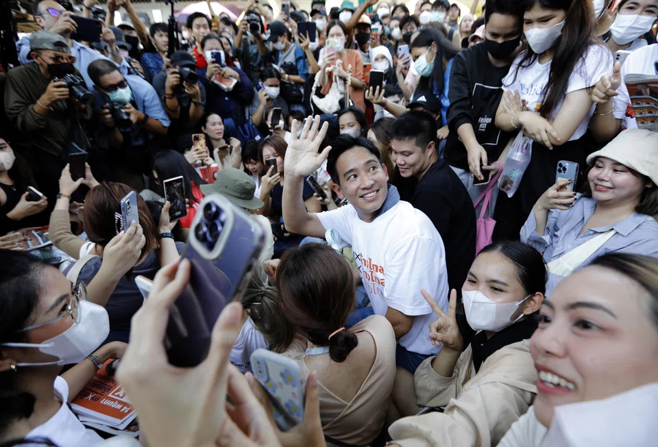 Pita Limjaroenrat (centre), the Move Forward Party's candidate for prime minister, greeting supporters during a campaign in Bangkok.