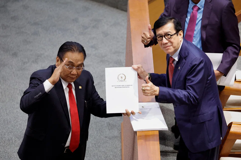 Yasonna Laoly, Indonesian Minister of Law and Human Rights (R), receives the new criminal code report from Bambang Wuryanto, head of the parliamentary commission. Yasonna says it's not easy for a multicultural and multi-ethnic country to make a criminal code that can accommodate all interests.