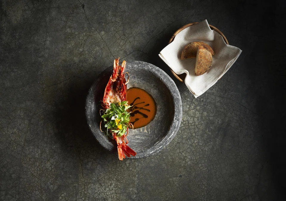 Giant carabinero prawns are split and grilled, served with rich prawn head sauce.