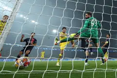 Dortmund's German defender Mats Hummels (centre) heads the ball past Paris Saint-Germain's Italian goalkeeper #99 Gianluigi Donnarumma (right) to score his team's first goal during the Uefa Champions League semi-final second leg football match between PSG and Borussia Dortmund at the Parc des Princes stadium in Paris, France, May 7, 2024. 