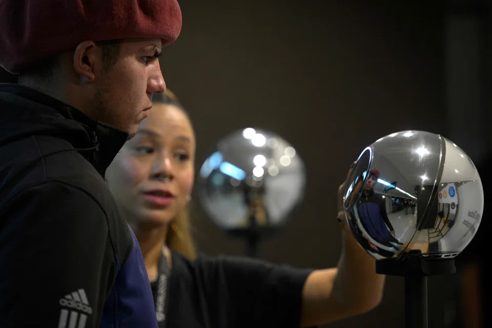 A man having his iris scanned with an orb, a biometric data scanning device, in exchange for the Worldcoin cryptocurrency.