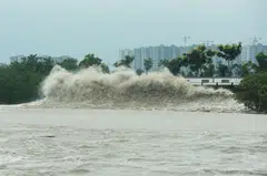 TOPSHOT - Waves generated by Typhoon Muifa along the coast in Hangzhou. China has higher exposure to physical hazards relating to climate change, including floods and tropical cyclones.