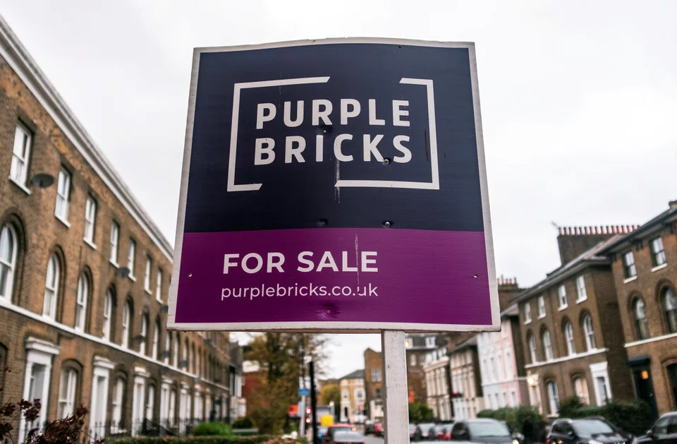 A sign for online estate agent Purplebricks is pictured outside a property in a residential street in London. According to agents and consultants of both buyers and sellers, quality apartments and houses in London and the south of England are in short supply.