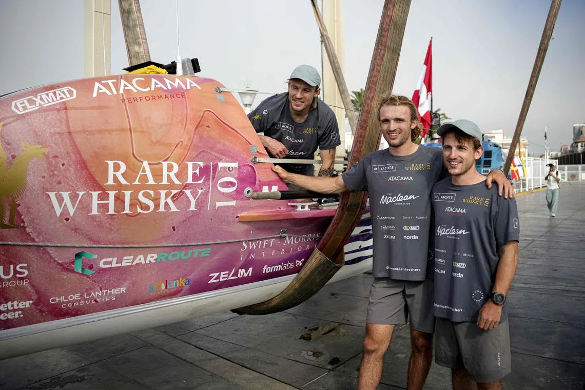 (L to R) Scottish brothers Jamie, Lachlan, and Ewan Maclean next to their boat before embarking on a mammoth journey from Peru to Sydney in Australia 14,500 km away.