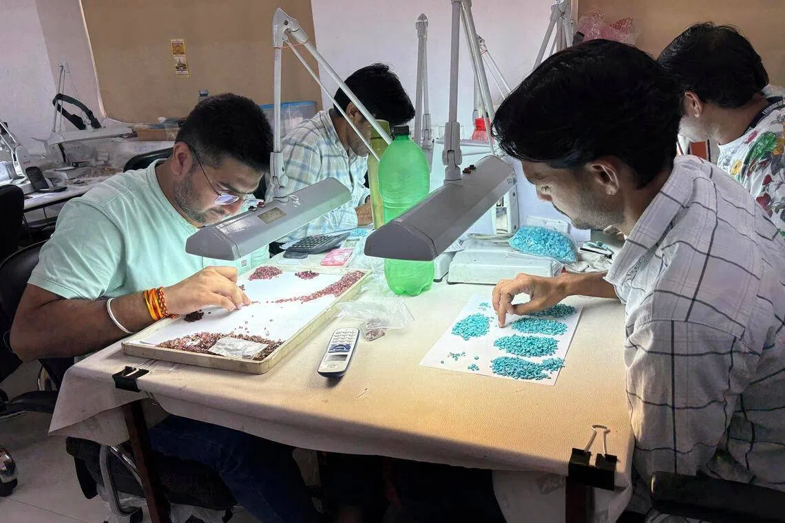 Artisans at work on gemstones at Lunawat Gems in Jaipur.