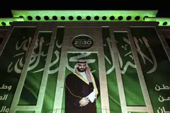 A poster promoting Vision 2030 showing Crown Prince Mohammed bin Salman on a building in Riyadh, Saudi Arabia.