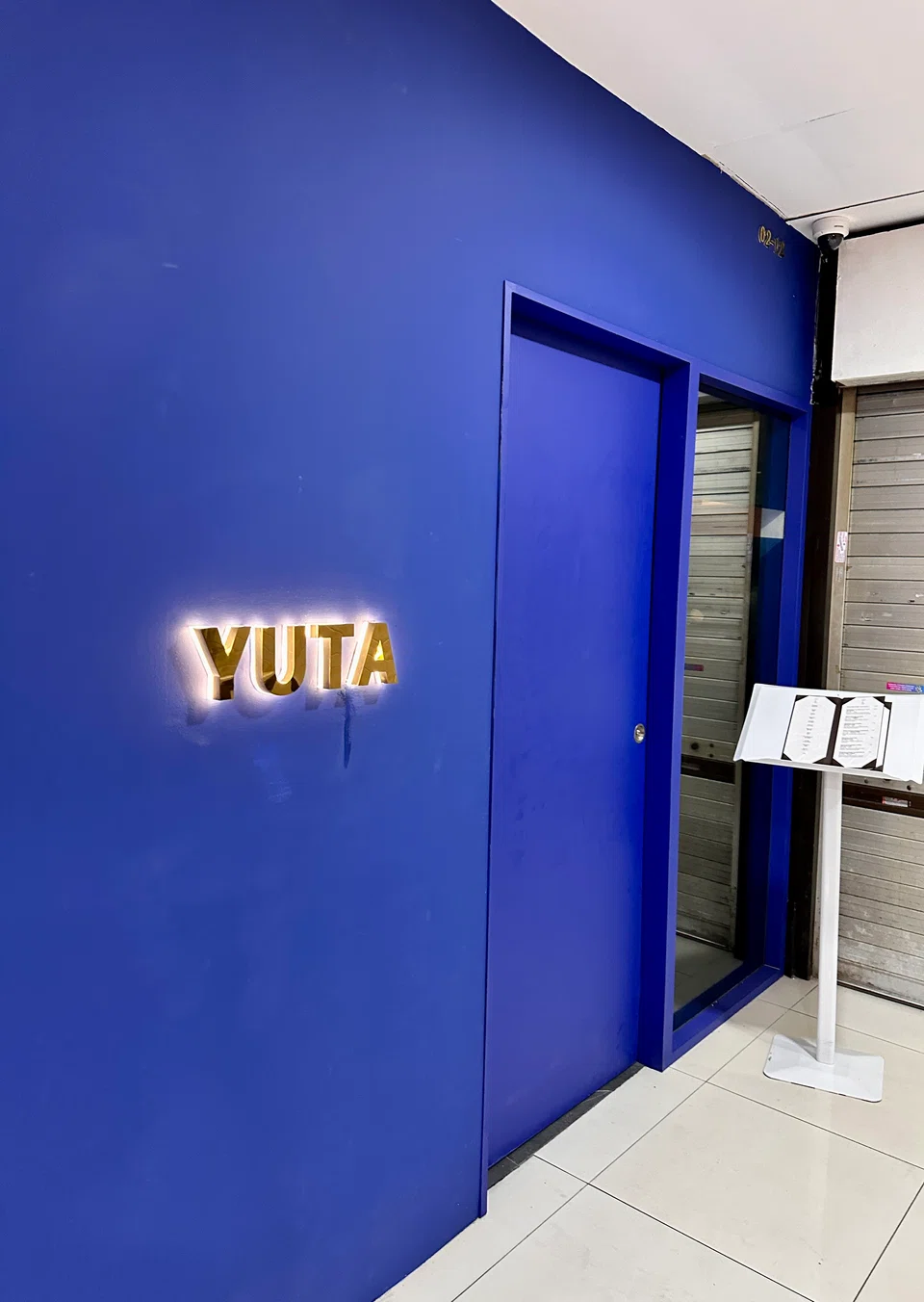 Yuta's bright blue facade stands out against its surroundings in Orchard Plaza.