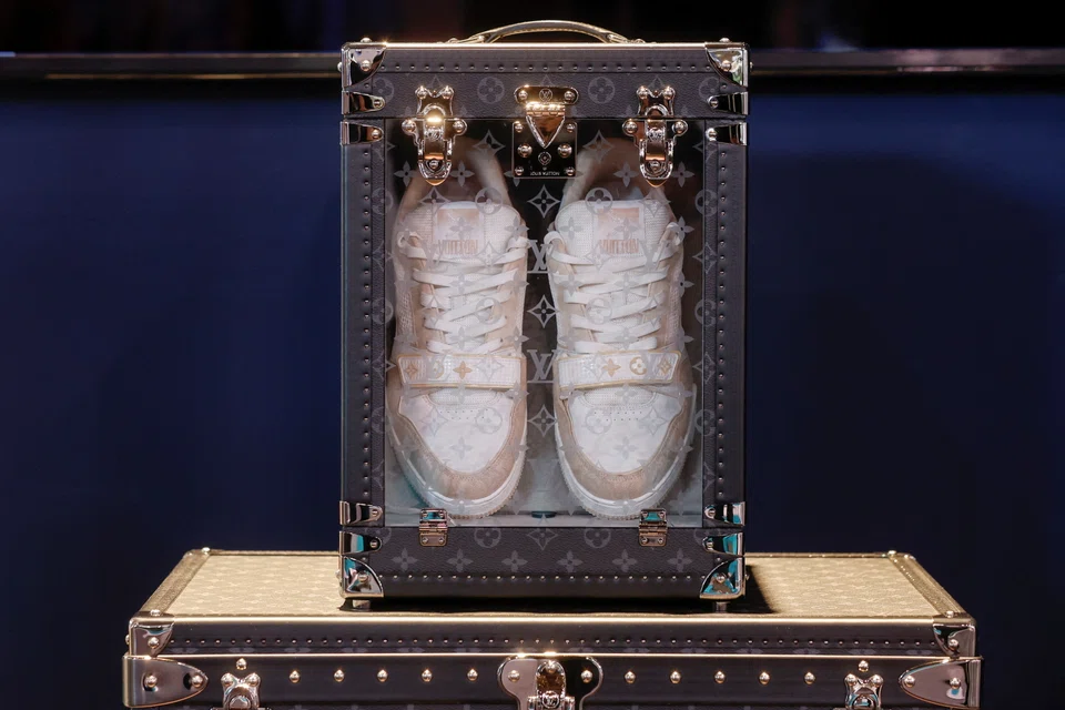 A pair of Louis Vuitton brand sneakers at Porte de Versailles exhibition center in Paris. Bain estimates that global sales of personal luxury goods will reach at least 305 billion euros this year.