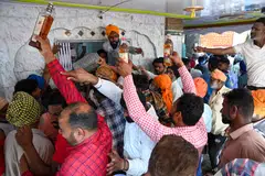 Devotees offer alcoholic beverages during a two-day annual fair at the shrine of Baba Rode Shah in Bhoma village on the outskirts of Amritsar, India, March 2023. According to WHO data, unrecorded alcohol accounts for about 26 per cent of total alcohol consumed in Asia.