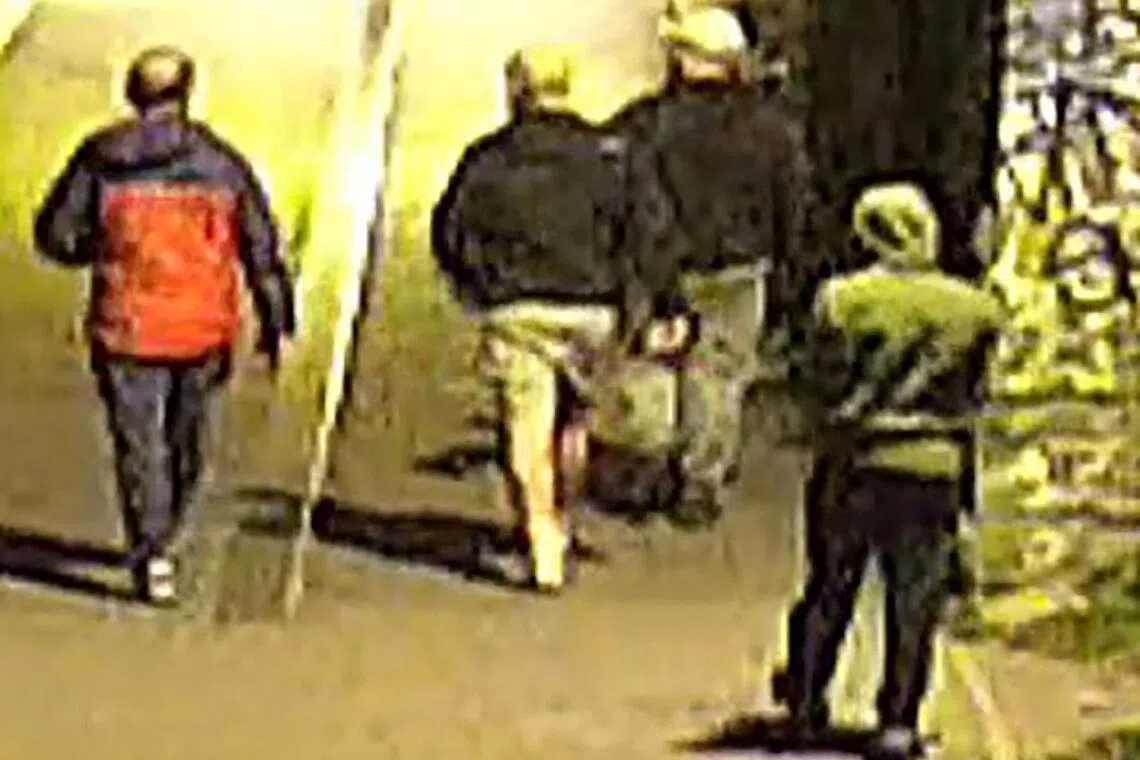 Four unidentified men, all wearing caps or hoodies, were seen in CCTV images carrying bags in the early hours. 