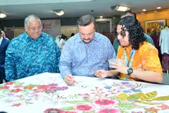 Securities Commission Malaysia chairman Mohammad Faiz Azmi (left) with Amir Hamzah Azizan, Minister of Finance II, Malaysia (middle) at a batik-making demonstration held alongside the ACMF International Conference 2025.