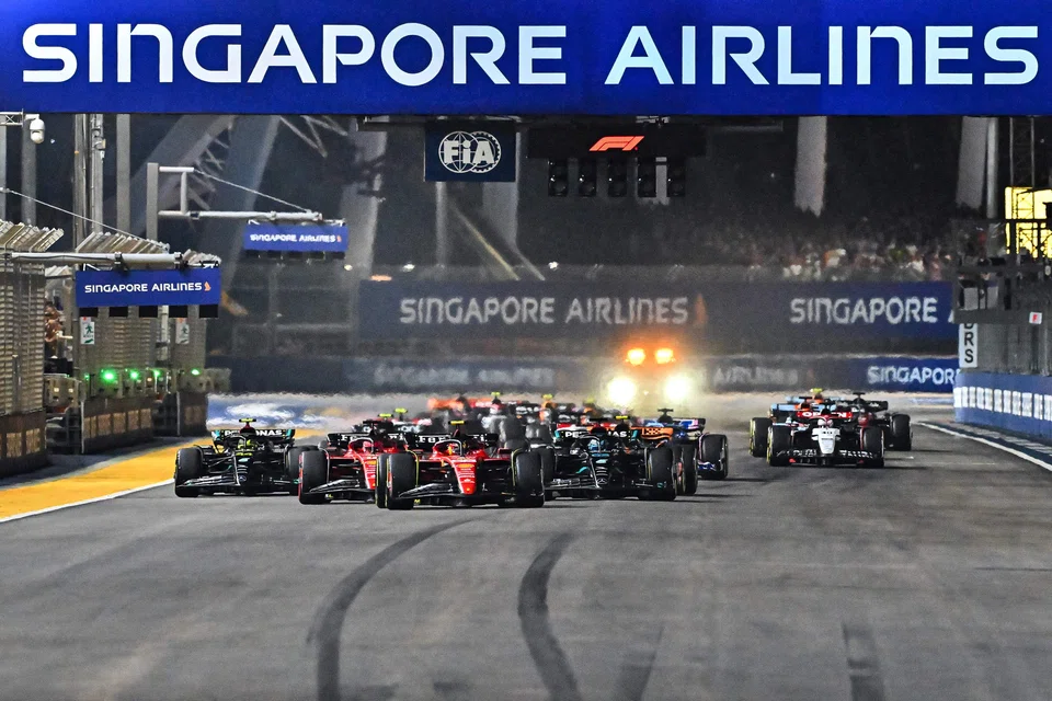 Ferrari's Spanish driver Carlos Sainz Jr (centre) drives in front of the field during the start of the Singapore Formula One Grand Prix night race at the Marina Bay Street Circuit in Singapore on Sunday. 