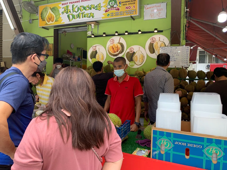 Consumers queueing to buy durian at a fruit stall in SS2, Petaling Jaya, Selangor.