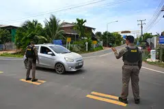 Thai police direct traffic during the villagers' evacuation, amidst clashes between Thai and Cambodian soldiers near the Thai-Cambodian border, in Ban Ta Miang, Surin province, Thailand on Jul 24.