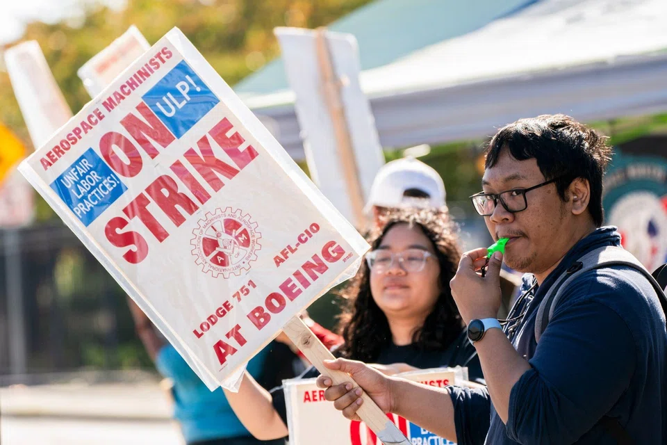 Workers picket outside the Boeing. manufacturing facility during a strike in Renton, Washington, Oct 3, 2024. 