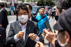 Former Japanese prime minister Shinzo Abe interacting with supporters in Tokyo on June 22, 2022, as he joined the election campaign for Liberal Democratic Party member Kentaro Asahi (not pictured) ahead of the House of Councillors election on July 10.