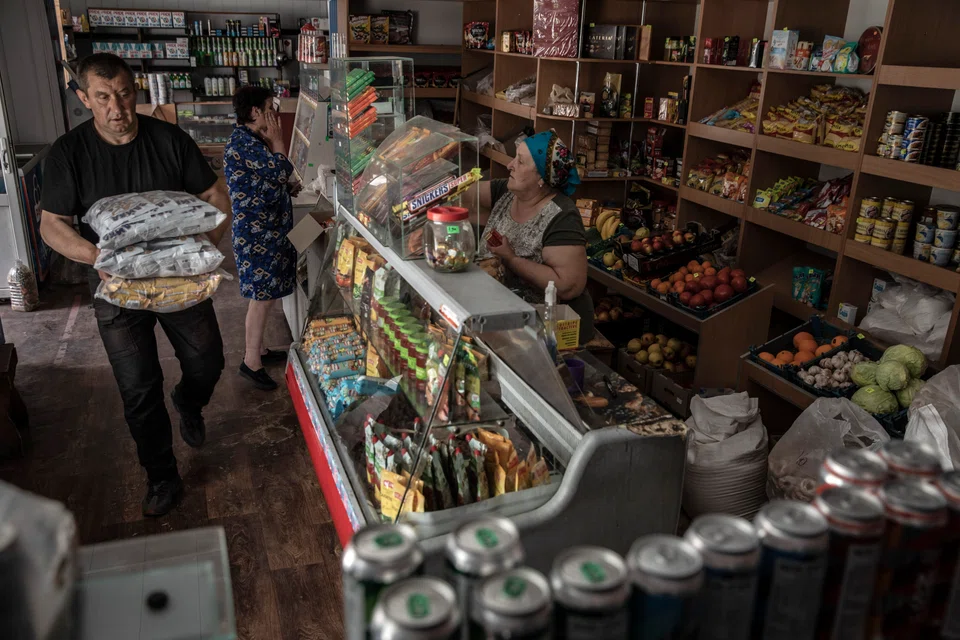Oleksandr Chaplik delivers goods to a village shop outside Sievierodonetsk, Ukraine, risking the drive in an area routinely hit by artillery shells to help keep it supplied for the area's residence, June 1, 2022. Chaplik is a fraying connection to the world for his increasingly isolated village. (Finbarr O'Reilly/The New York Times)