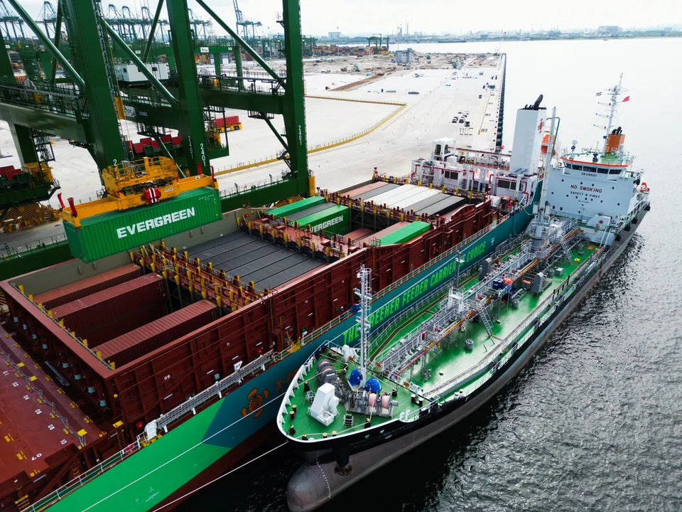 X-Press Feeders' cargo vessel Eco Maestro (middle) simultaneously taking on cargo at Tuas Port and being refuelled with methanol by bunker ship MT Kara (right). 