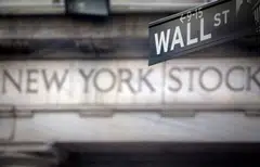 FILE PHOTO: A Wall Street sign is pictured outside the New York Stock Exchange in New York, October 28, 2013. REUTERS/Carlo Allegri/File Photo