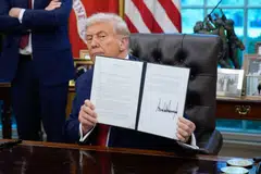 US President Donald Trump displays a signed executive order in the Oval Office of the White House in Washington, D.C., US, Sep 25, 2025. Trump advanced plans for American investors to buy TikTok’s US operations from its Chinese owner ByteDance.