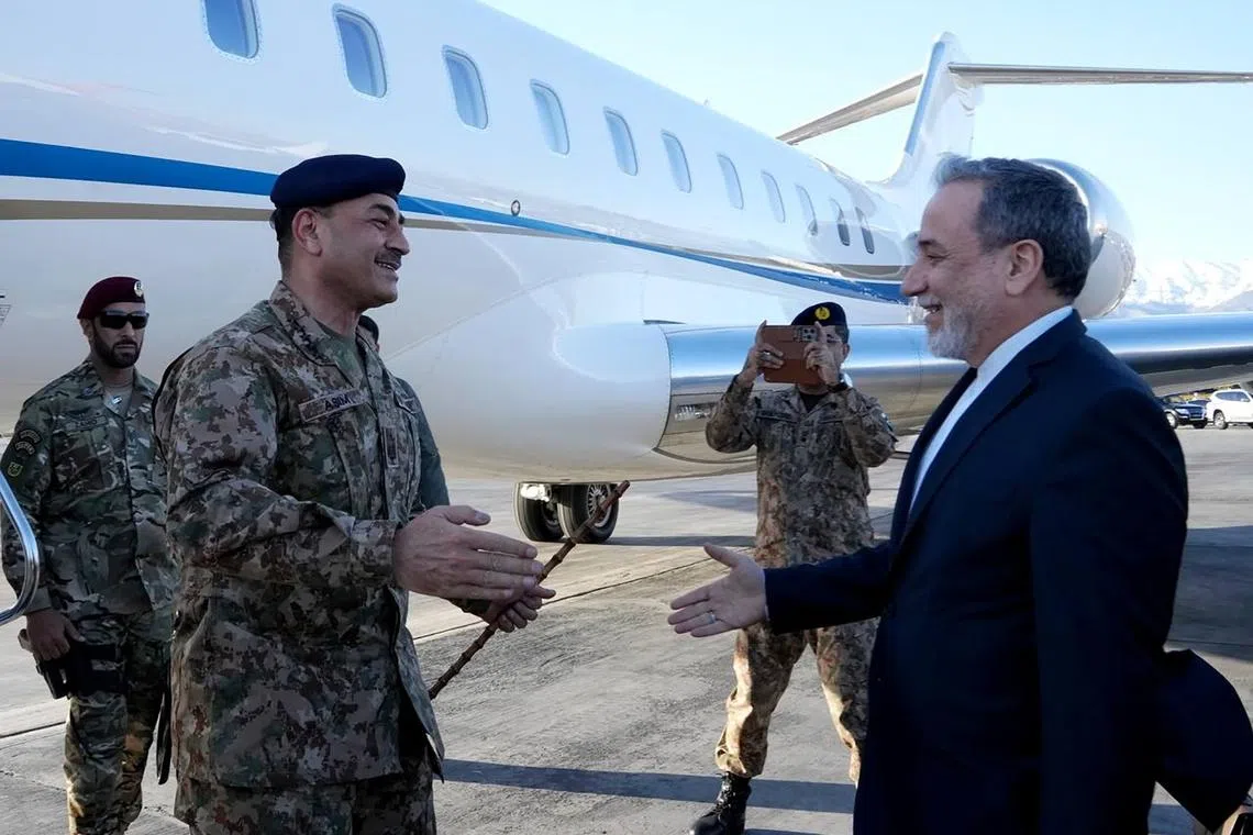 Iran's Foreign Minister Abbas Araghchi (right) welcomes Pakistan’s army chief Field Marshal Asim Munir (left) at an airport in Teheran on Apr 15.