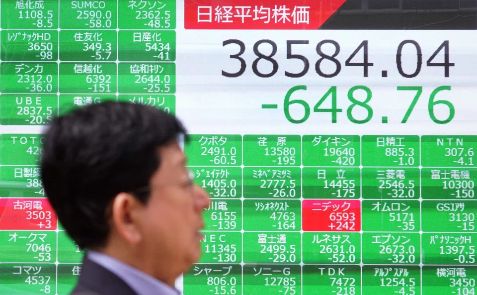A man walks past an electronic board showing the Nikkei index of the Tokyo Stock Exchange in Tokyo, Japan, April 16, 2024. Tokyo, Hong Kong, Shanghai, Seoul, Singapore, Taipei, Wellington, Manila and Jakarta stocks were all sharply down on Tuesday.