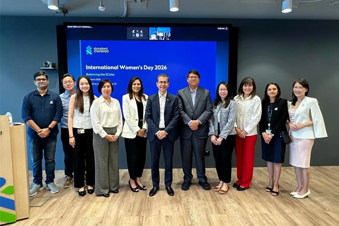 Standard Chartered's CEO for Singapore, Asean and South Asia Patrick Lee (centre) joins others from the bank to mark International Women's Day 2026.