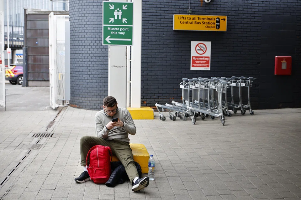 A traveller waiting at Heathrow Airport on Mar 21 after the airport announced it would be closed all day.