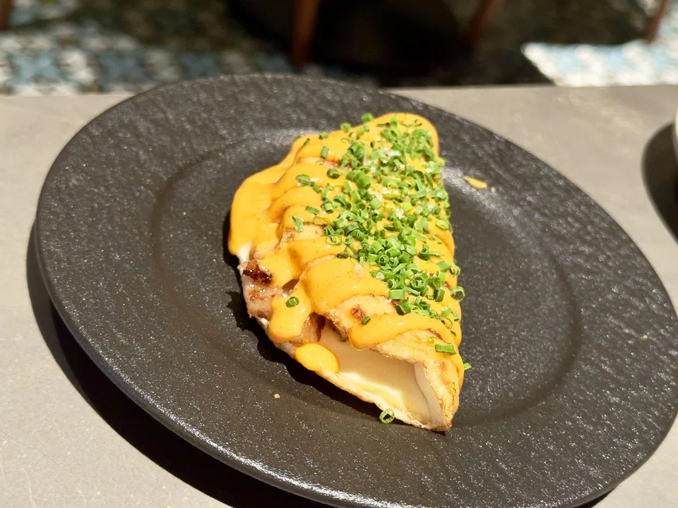 Sweetcorn pancake filled with fried egg and pork jowl.